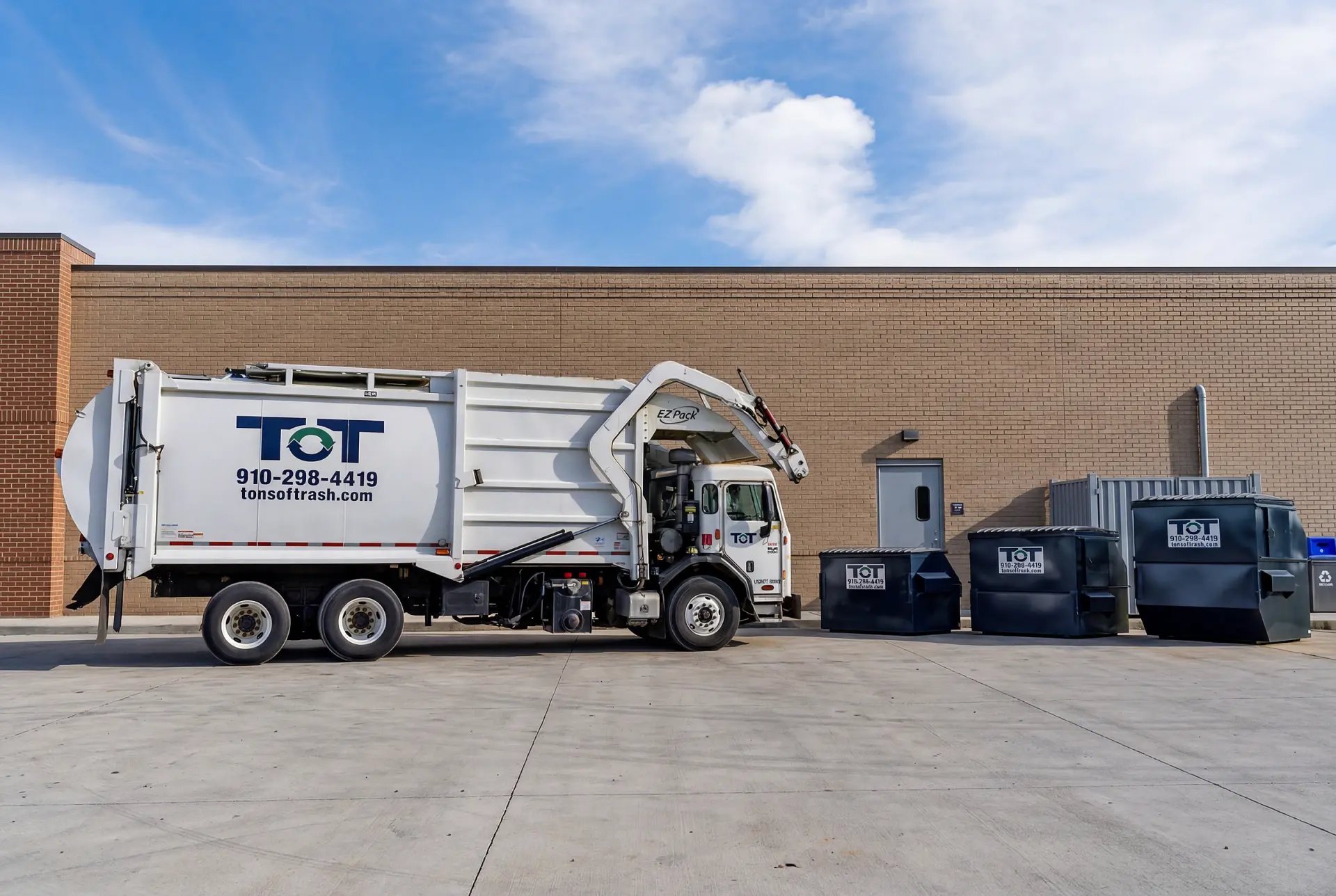 Tons of Trash front-end loader truck with commercial dumpster containers in eastern North Carolina