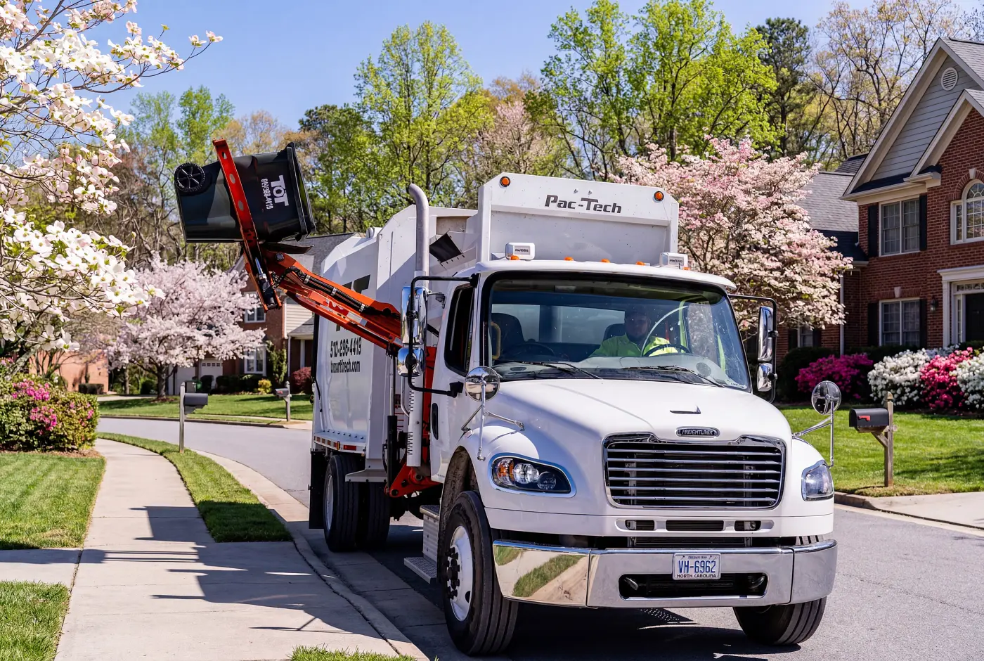 Tons of Trash residential pickup truck collecting a curbside bin in eastern North Carolina